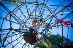 Children climbing on a large geodesic dome rope climber at Taylor Park.