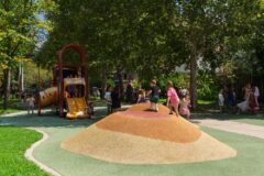 two kids walk up colorful climbing mounds