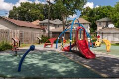 blue, red, and yellow playground equipment themed around cars